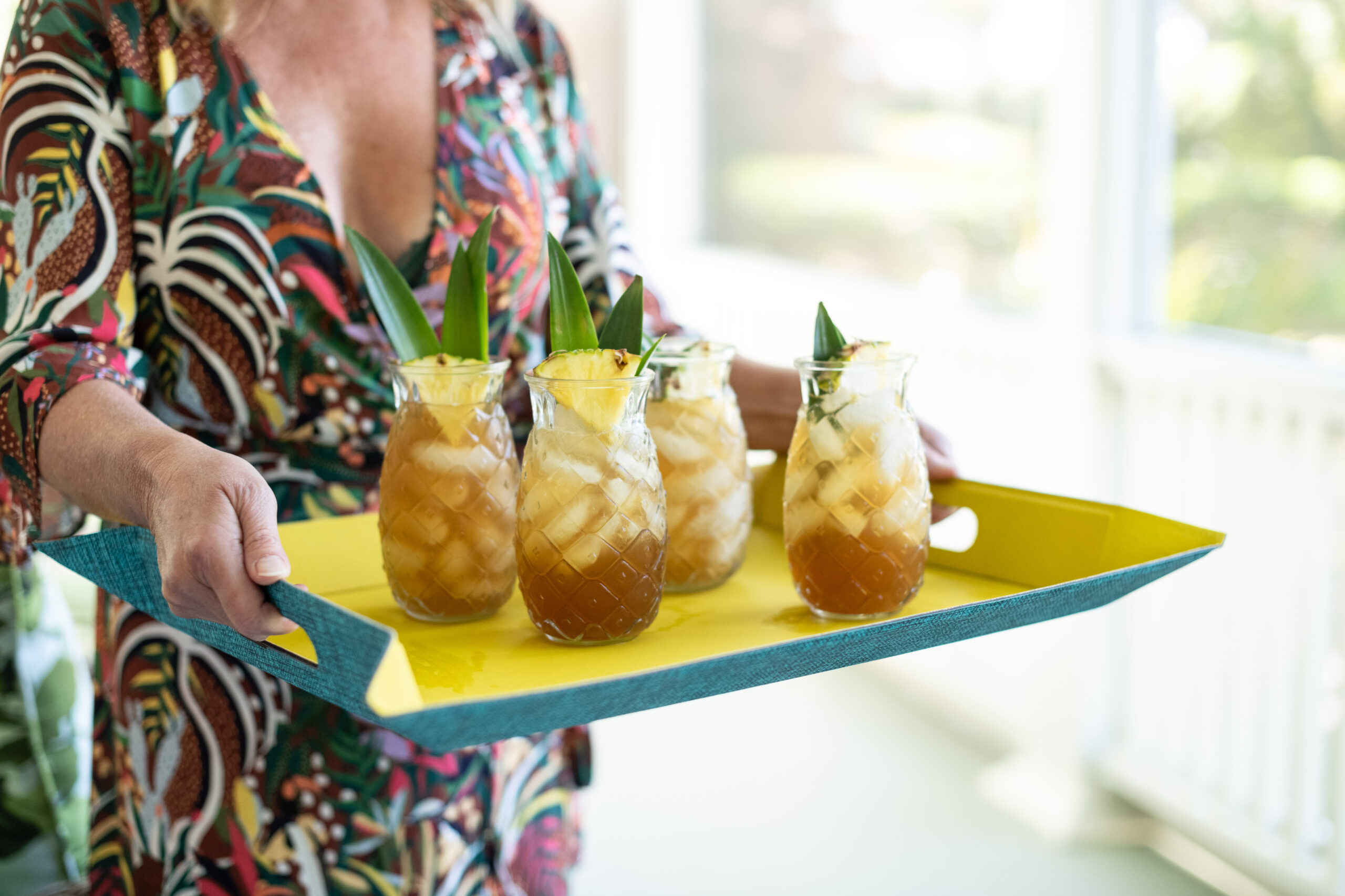 Serving welcome drinks on Sun Cookery tray and pineapple glasses!